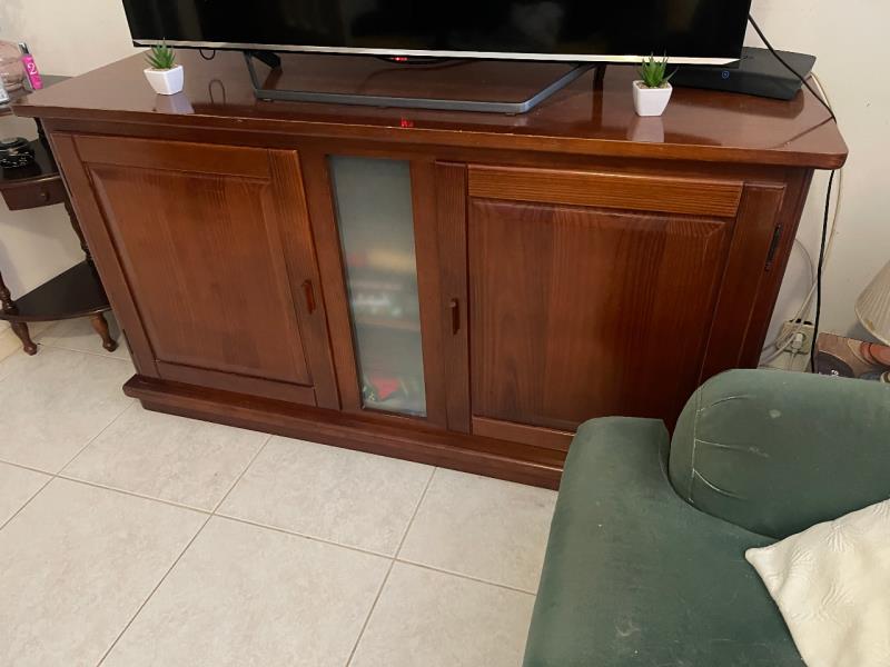 Fotografia de mobiliário: Um móvel de TV com duas portas de madeira de cor castanha escuro